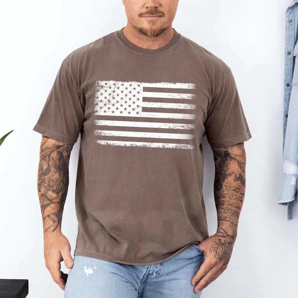 Man wearing a brown t-shirt with an American flag design against a white background