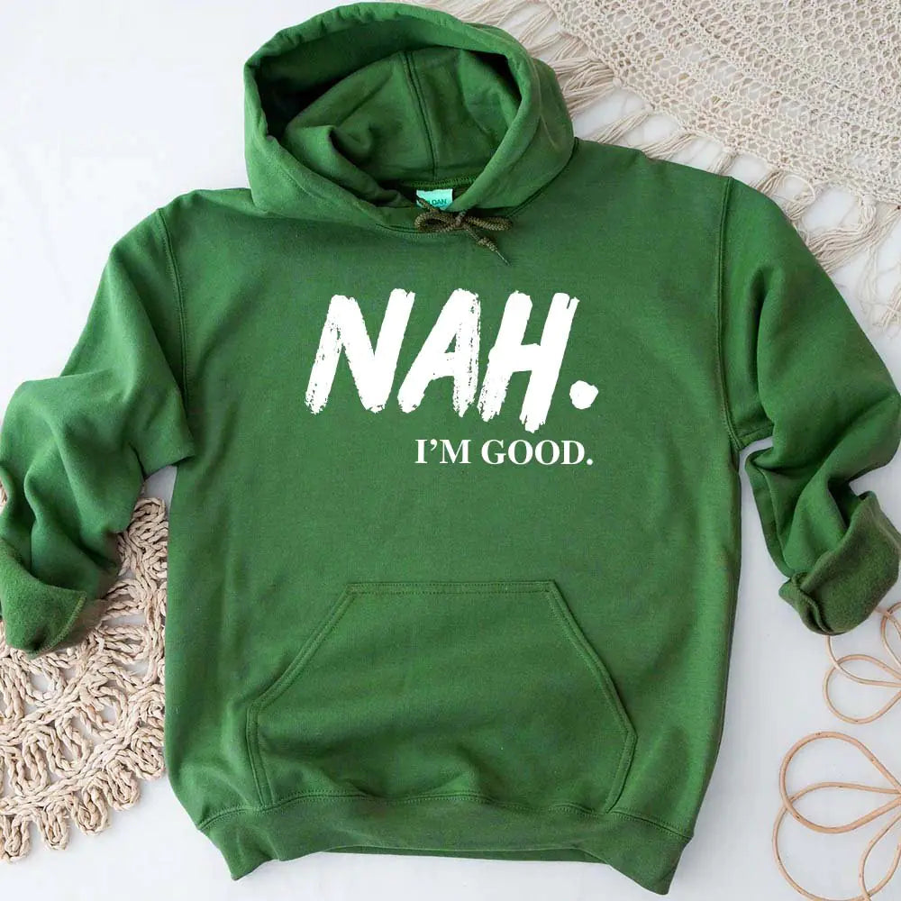 Green hoodie with 'NAH. I'M GOOD.' text on a textured surface