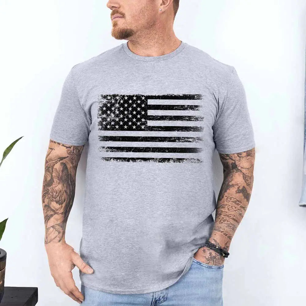 Man wearing a gray t-shirt with an American flag design against a white background