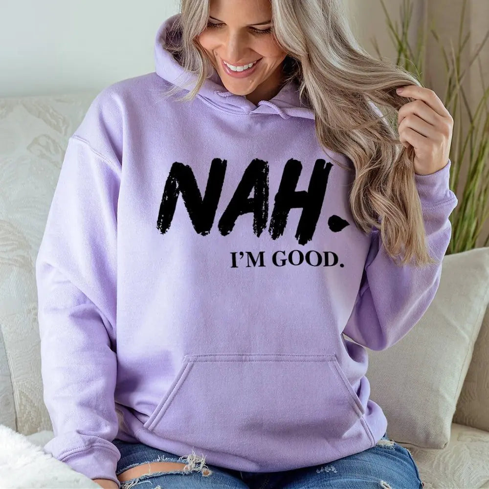 Person wearing a purple hoodie with 'NAH. I'M GOOD.' text, sitting on a couch.